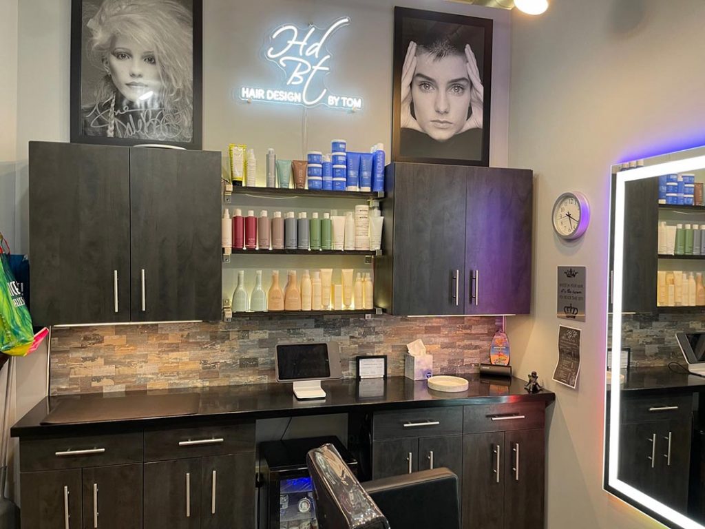 Hair Design By Tom salon interior with product shelves